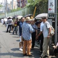 Fish fans: People waiting in line at a popular eel restaurant near Minami Senju Station in Tokyo | REUTERS