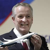 Malaysia Airlines Berhad (MAS) new Chief Executive Officer Peter Bellew holds a Boeing 737 MAX airplane model after a signing ceremony with Boeing in Putrajaya, Malaysia, Wednesday. Malaysia Airlines Berhad and Boeing announced a deal of 50 new 737 Max aircraft. Boeing bags $5 billion deal with recovering Malaysia Airlines, $1 billion India patrol jet sale