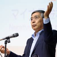 Bank of Japan Gov. Haruhiko Kuroda gestures during a lecture at Keio University in Tokyo on June 20. | BLOOMBERG