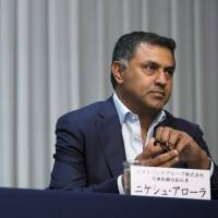 SoftBank CEO Masayoshi Son (left) and Nikesh Arora, then Japan’s highest-paid executive, are seen May 10. Rule No. 1 for scoring big pay in Japan: Don't be Japanese