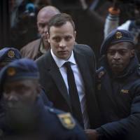 Oscar Pistorius arrives at the High Court in Pretoria on Wednesday. A judge sentenced the former Olympian for murdering his girlfriend on Valentine’s Day 2013. Oscar Pistorius sentenced to six years in prison for murder
