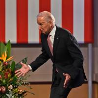 U.S. Vice President Joe Biden stumbles while walking onto the stage to deliver a speech at the Paddington Town Hall in Sydney on Wednesday. | AFP-JIJI