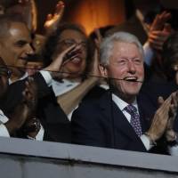 Former President Bill Clinton applauds as first lady Michelle Obama speaks during the first day of the Democratic National Convention in Philadelphia  Monday. | AP
