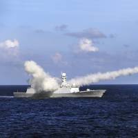 The Chinese frigate Yuncheng launches an anti-ship missile during a military exercise in waters near south China\'s Hainan Island and the Paracel Islands on Friday. | AP