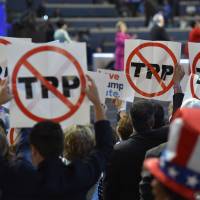Delegates show their opposition to the Trans-Pacific Partnership deal during Day 1 of the Democratic National Convention in Philadelphia on Monday. | AFP-JIJI