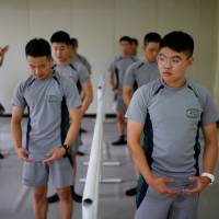 South Korean soldiers take part in a ballet class at a military base near the Demilitarized Zone separating the two Koreas in Paju, South Korea, on Wednesday. At heavily fortified DMZ, South Korean troops swap boots for ballet shoes