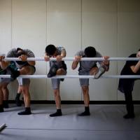 Wearing shorts and T-shirts along with their dancing slippers, members of the South Korean Army\'s 25th Division are taught each week by a ballerina from the Korean National Ballet. | REUTERS