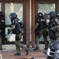 Police raid a building in Hildesheim, Germany, on Wednesday. Authorities say police have raided a mosque believed to be a \"hot spot\" for Islamic extremists in the city as well as the apartments of eight leading members of the \"German-speaking Islam Circle Hildesheim\" organization. | AP