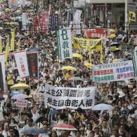An annual pro-democracy protest takes place in Hong Kong on Friday. The disappearance of booksellers angered many. | AP