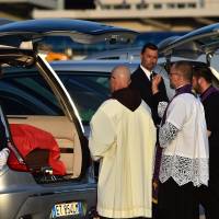 Priests bless the coffins of the nine Italians killed in the Bangladesh attack, at the Ciampino military airbase near Rome Tuesday. | AFP-JIJI