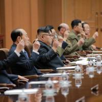 North Korean leader Kim Jong Un (center) attends the Fourth Session of the 13th Supreme People\'s Assembly (SPA) of North Korea in this undated photo released by North Korea\'s Korean Central News Agency (KCNA) in Pyongyang Thursday. | KCNA / REUTERS