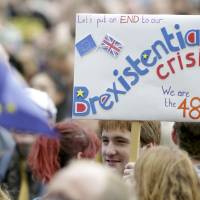 A man holds up a banner during a demonstration against Britain\'s decision to leave the European Union in central London on Saturday. | REUTERS