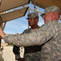 A U.S. commander inspects a THAAD unit at Guam\'s Andersen Air Force Base in this file image from August 2013. | U.S. ARMY