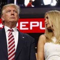 Republican presidential nominee Donald Trump stands in the Trump family box with his daughter Ivanka awaiting the arrival onstage of his son Eric at the Republican National Convention in Cleveland on Wednesday. | REUTERS