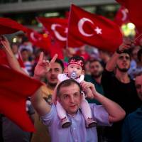 Government supporters wave Turkish flags and shout slogans during a protest in Taksim Square, Istanbul, Tuesday The Turkish government accelerated its crackdown on alleged plotters of the failed coup against President Recep Tayyip Erdogan. | AP