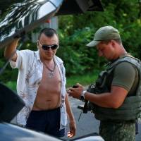 A Ukrainian serviceman checks documents at a checkpoint near Slovyansk, in Ukraine\'s Donetsk region, on June 29. | REUTERS
