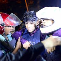 An injured police officer is carried away by colleagues after gunmen stormed a restaurant popular with expatriates in the diplomatic quarter of the Bangladeshi capital, Dhaka, on Friday. | REUTERS