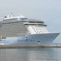The cruise ship Quantum of the Seas arrives at Yatsushiro port in Kumamoto Prefecture on Thursday. | KYODO