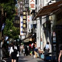 Yasukuni-dori is lined with shops selling used books in Tokyo’s Jinbocho district. | SATOKO KAWASAKI