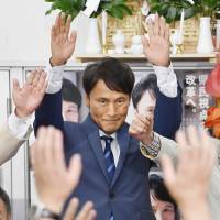 Satoshi Mitazono, a former TV Asahi Corp. commentator, cheers during the Kagoshima gubernatorial election in the city of Kagoshima on Sunday. | KYODO