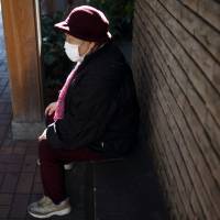 A woman sits on a bench in Tokyo\'s Sugamo district. Data released by the welfare ministry show that Honk Kong has surpassed Japan for the world\'s top spot in average life expectancy for women. | BLOOMBERG