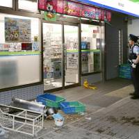 Police investigate the scene of a rampage perpetrated by young men outside a convenience store in Kobe\'s Suma Ward Sunday evening. | KYODO