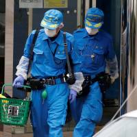 Police officers exit the Tsukui Yamayuri En care facility in Sagamihara, Kanagawa Prefecture, on Tuesday. | REUTERS