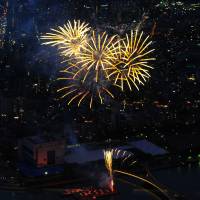 Fireworks are seen from Tokyo Skytree\'s observation deck on Saturday in Tokyo\'s Sumida Ward. | YOSHIAKI MIURA