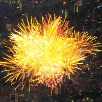 Fireworks are seen from Tokyo Skytree\'s observation deck on Saturday in Tokyo\'s Sumida Ward. | YOSHIAKI MIURA