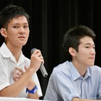 Rei Higa, a third-year student at Okinawa Prefectural Futenma High School, speaks at a symposium in Matsuyama, Ehime Prefecture, on Sunday. | KYODO