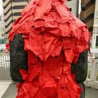 Akagami Nio (Red Paper Deva Kings) was originally carved in 1641 with hopes of eradicating a plague. Today, people place red papers on the statues in areas that ail them. | KIT NAGAMURA
