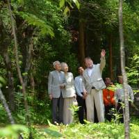 Back to basics: Emperor Akihito and Empress Michiko listen to C.W. Nicol as they walk together in the Afan Trust’s woods in Shinano, Nagano Prefecture, in June. | COURTESY OF THE C.W. NICOL AFAN WOODLAND TRUST