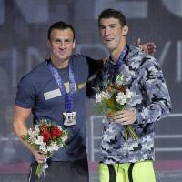 Ryan Lochte (left) and Michael Phelps embrace during the men\'s 200-meter backstroke medal ceremony at the U.S. Olympic swimming trials, on Friday in Omaha, Nebraska. Phelps won the gold medal ahead of Lochte, who came in second. Also Friday, Phelps and Lochte finished 1-2 in the 200 individual medley. | AP