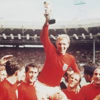 England captain Bobby Moore holds the Jules Rimet Trophy aloft as he is carried off the pitch at Wembley Stadium on July 30, 1966, after a 4-2 victory over West Germany in the World Cup final. | AP