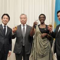 Rwandan Ambassador Venetia Sebudandi (second from right) prepares for a toast with, from left, Parliamentary Vice-Minister for foreign Affairs Masakazu Hamachi; Specialty Coffee Association of Japan President Shinji Sekine; and State Minister of Finance and Secretary-General of the Japan-Rwanda Parliamentary League of Friendship Manabu Sakai during a reception to celebrate the country\'s Liberation Day and Independence Day at the Toshi Center Hotel, in Tokyo on July 4. | YOSHIAKI MIURA