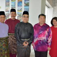 From left: Ambassador of Brunei to Japan Mahamud Ahmad; Director of Tourism Malaysia in Japan Noor Azlan Abu Bakar; Ambassador of Malaysia to Japan Dato\' Ahmad Izlan Idris; CEO of Eitoshin Shoji Co. Datuk Seri Tam Yun Tong; and Director of Eitoshin Shoji Co. Datin Seri Ang Hui Chin pose at an event to celebrate the Eid al-Fitr festival at the Malaysian Embassy in Tokyo on July 6. | EDLEEN OTHMAN
