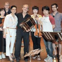 Argentine bandoneonist Rodolfo Mederos (fourth from right) and Argentine Society of Music Authors and Composers Japan representative Hiroko Matoba (fifth from right) pose with Japanese musicians (from left) Tsukasa Kasuya; Momoko Aida; Izumi Kawamura; bandoneonist Ryota Komatsu; Takahiro Uchida; and Mederos\' manager Gustavo Frojan (back row) following a rehearsal for a joint concert to celebrate the Bicentennial of the Independence Day of the Argentine Republic at Keyaki Hall at the Koga Masao Museum of Music in Tokyo on July 12. | YOSHIAKI MIURA
