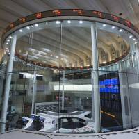 Stock tickers are displayed on the trading floor of the Tokyo Stock Exchange. Thanks to increases in ETF purchases, the Bank of Japan has been prominently boosting its presence in the nation’s stock market. The BOJ's unstoppable rise to shareholder No. 1 in Japan