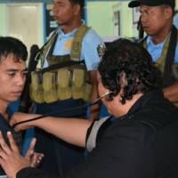 A government doctor checks Indonesian hostage Mohammad Safyan after he escaped from Abu Sayyaf captors, in Jolo, Sulu, in southern Philippines Wednesday. | REUTERS