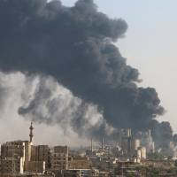 A general view shows rising smoke from a Syrian regime controlled cement factory, in Aleppo, Syria, Tuesday. | REUTERS