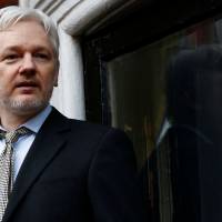 WikiLeaks founder Julian Assange makes a speech from the balcony of the Ecuadorian Embassy in London on Feb. 5. | REUTERS