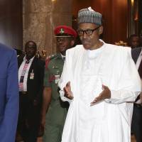 Nigerian President Muhammadu Buhari talks with United States Secretary of State John Kerry at the presidential villa in Abuja on Tuesday. Kerry praised Nigeria for its recent gains against Boko Haram Islamists. | AFP-JIJI