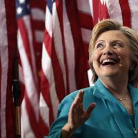 Democratic U.S. presidential nominee Hillary Clinton looks up to audience members as she leaves a campaign event at Truckee Meadows Community College in Reno, Nevada, on Thursday. | AP