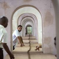 Cubans roll a 90-meter cigar, stretching through many rooms, in Havana on Friday. | AP