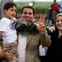 Iranian scientist Shahram Amiri flashes the victory sign as he arrives at the Imam Khomini Airport in Tehran in 2010. A hero or U.S. spy, Iran nuke scientist claimed innocence before hanging: mother