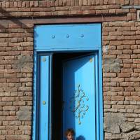 An Afghan girl sits at the entrance to her home on the outskirts of Kabul Sunday. | AP