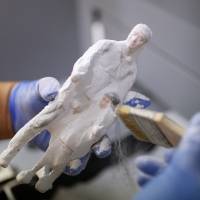 A 3-D printed figure is cleaned at a printing company in Seoul on Friday. | REUTERS