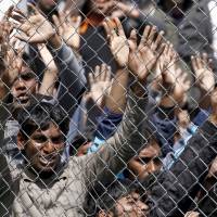 Migrants who will be returned to Turkey demonstrate inside the Moria registration center on the Greek island of Lesbos, April 5. | REUTERS