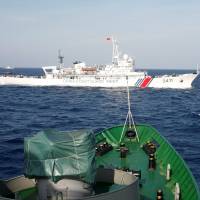 A China Coast Guard ship is seen crossing the path of a Vietnam Marine Guard vessel in the South China Sea, about 210 km off the Vietnamese coast, in 2014. | REUTERS