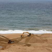 An excavator works at a land reclamation project at the Colombo Port City construction site, which is backed by Chinese investment, in the Sri Lankan capital on Aug. 9. | REUTERS